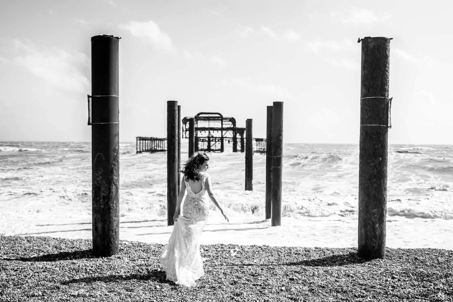 bride looking to the side standing amid west pier remnants