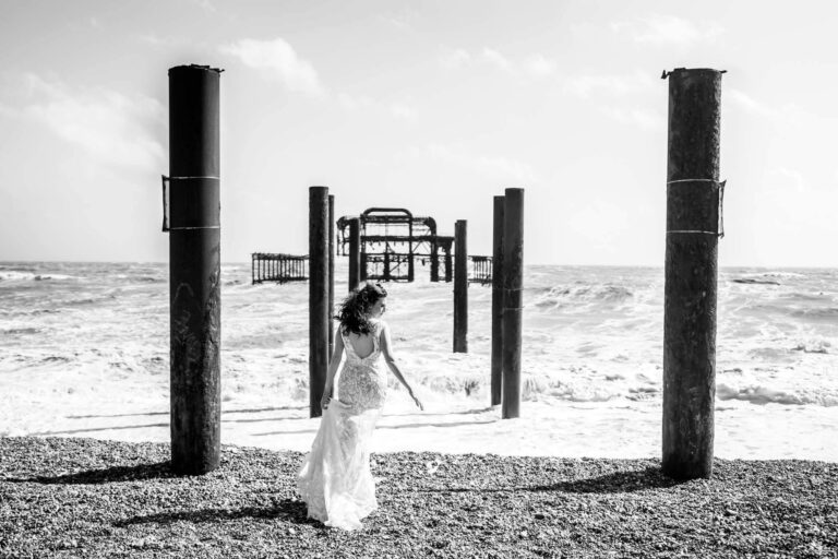 bride looking to the side standing amid west pier remnants
