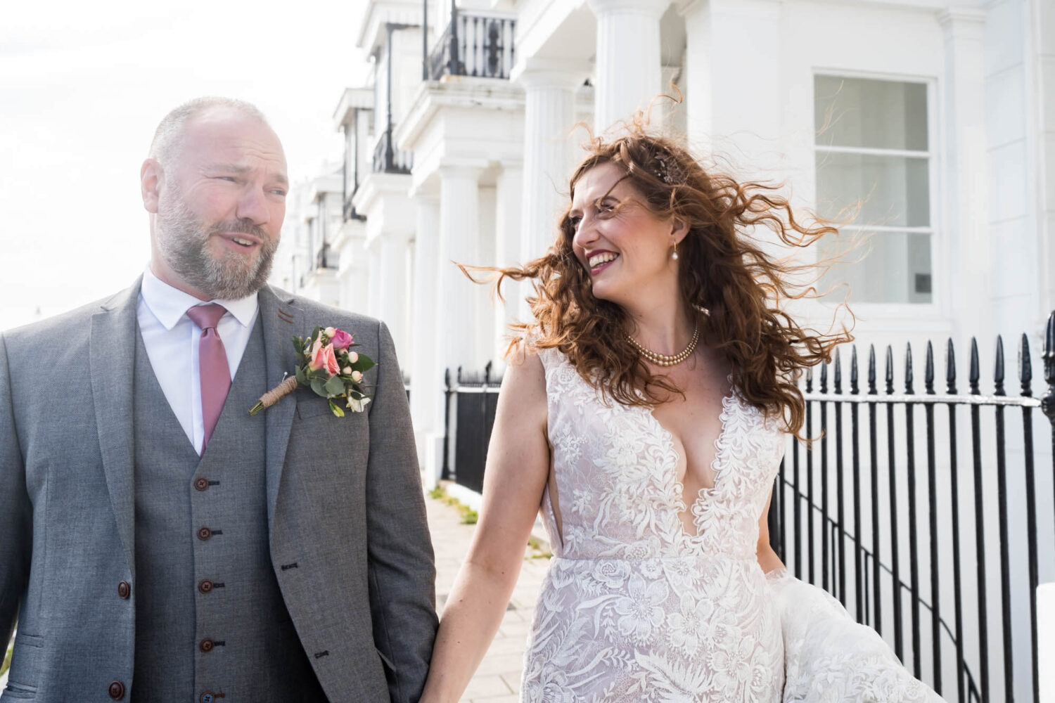 smiling bride and groom with wind swept hair brighton wedding