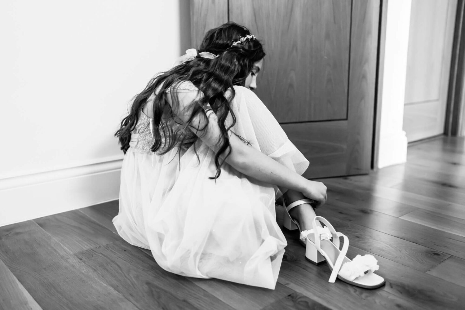 bridesmaid on floor tying up shoe lace