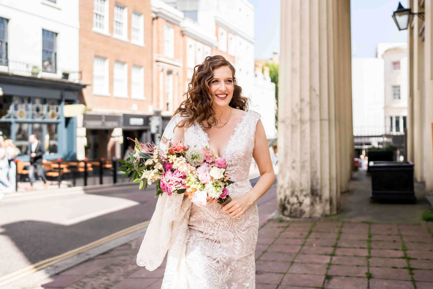 bride smiling walking towards ceremony hall