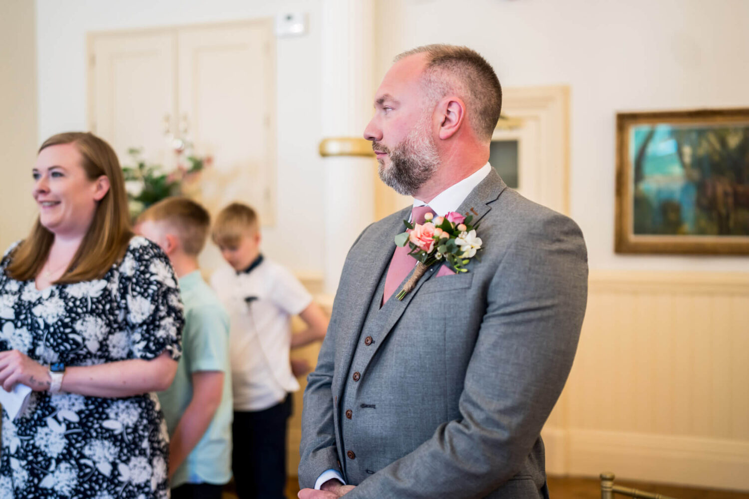 groom looking away from the camera waiting for bride to arrive