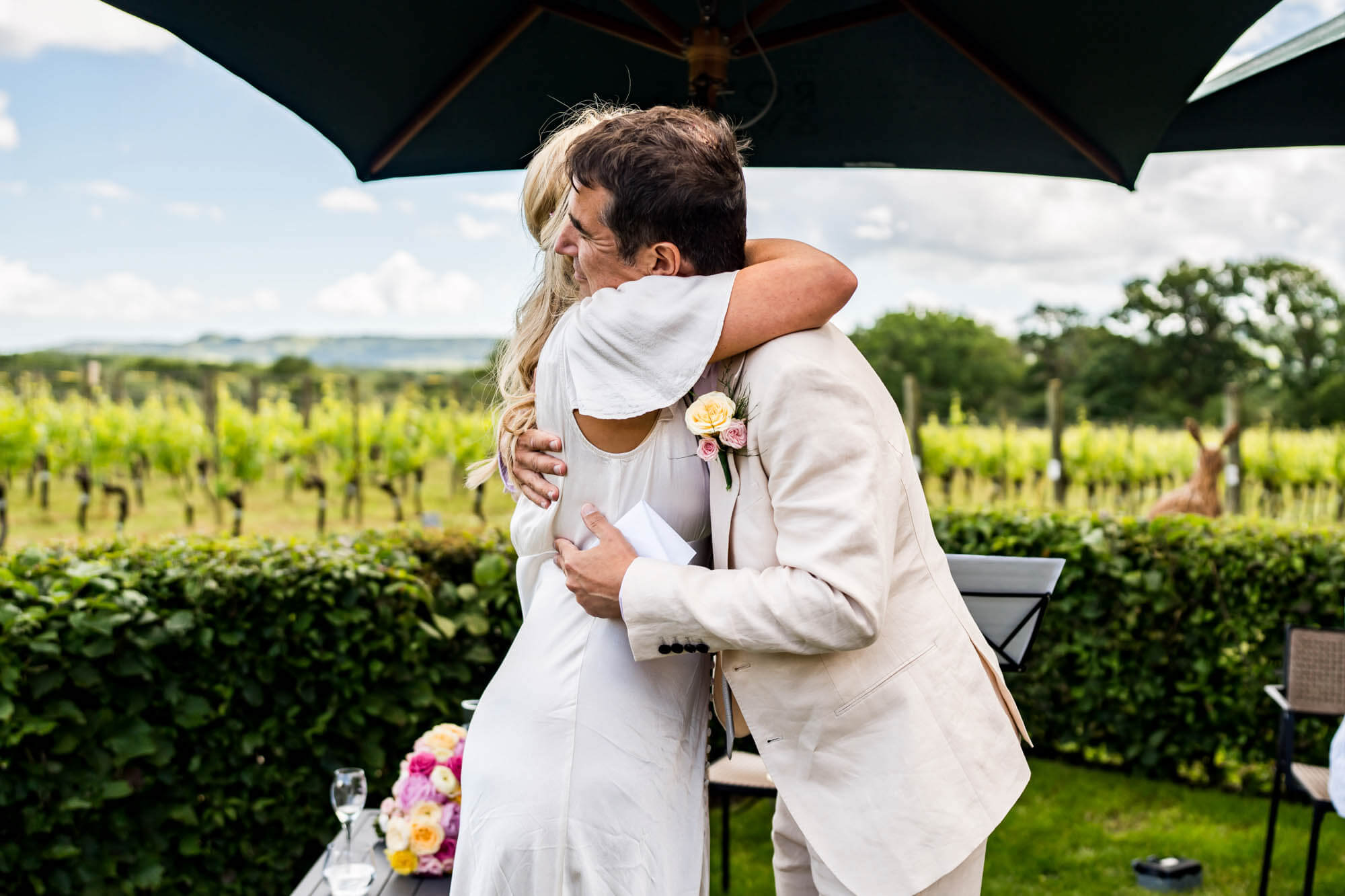 Bride and groom hugging.