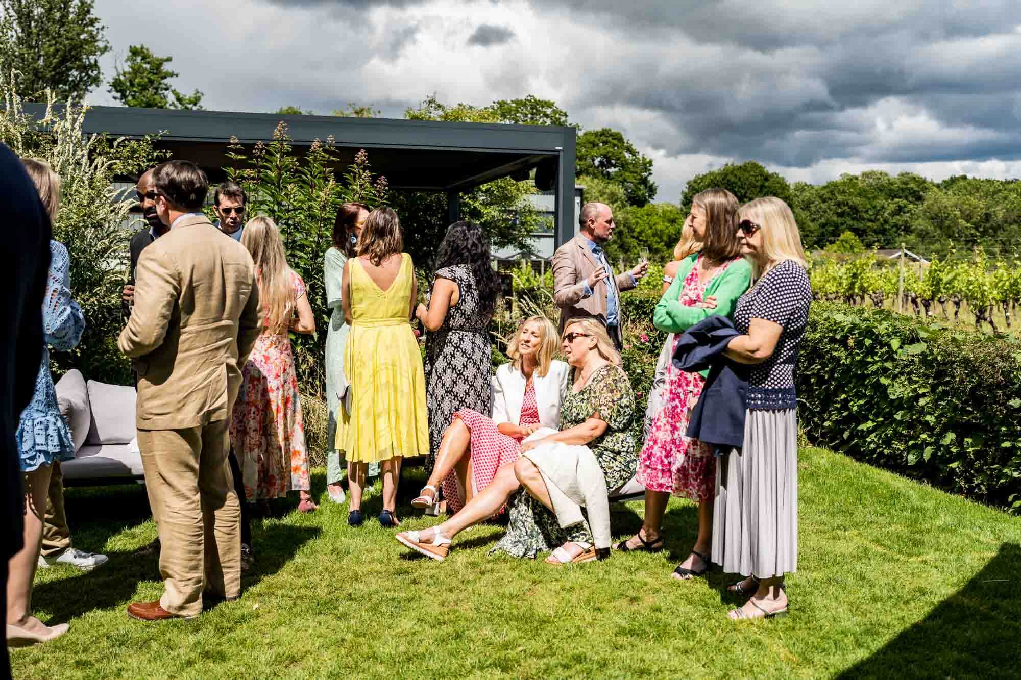 Guests talking upon grass.