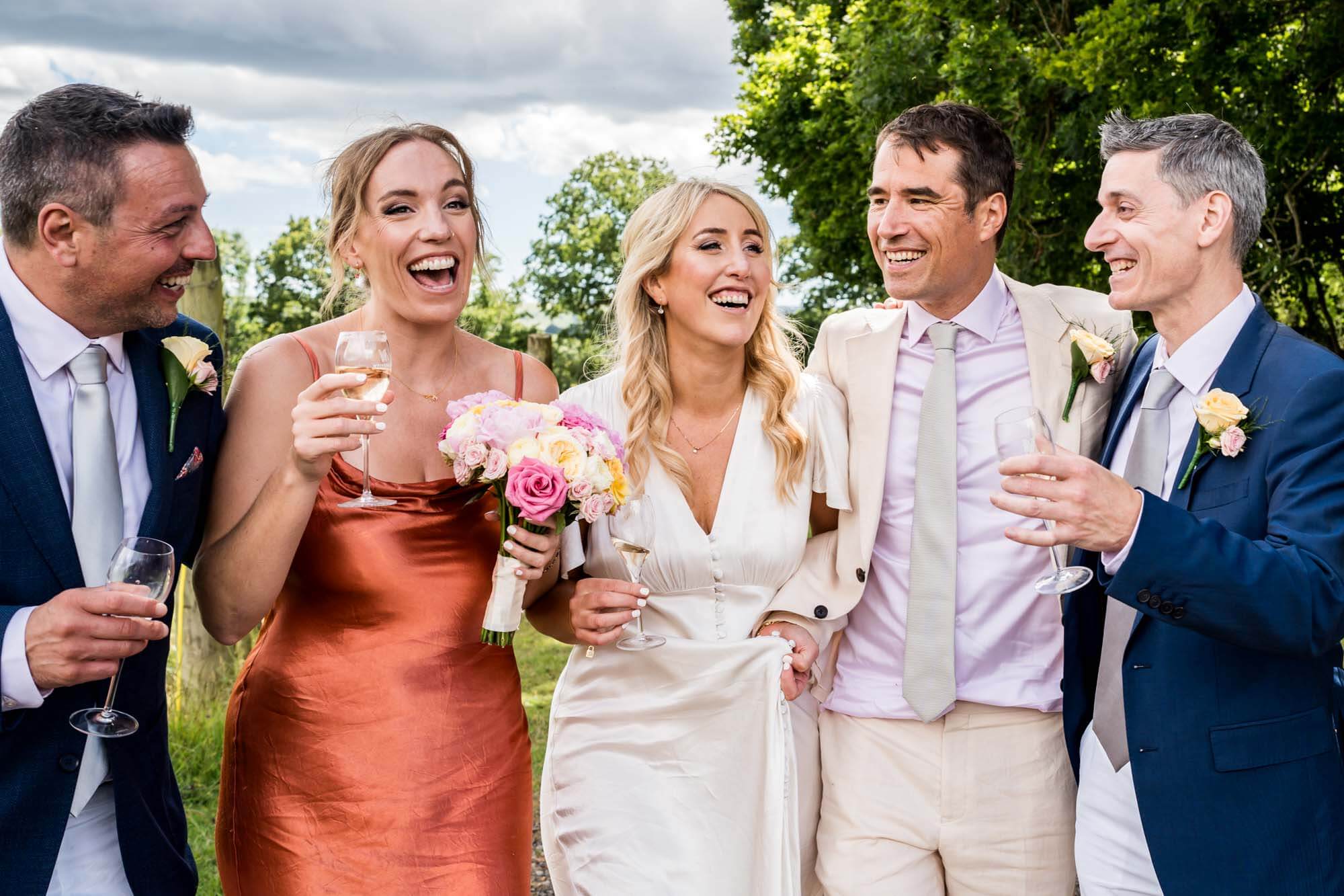 Bride, groom and guests talking.