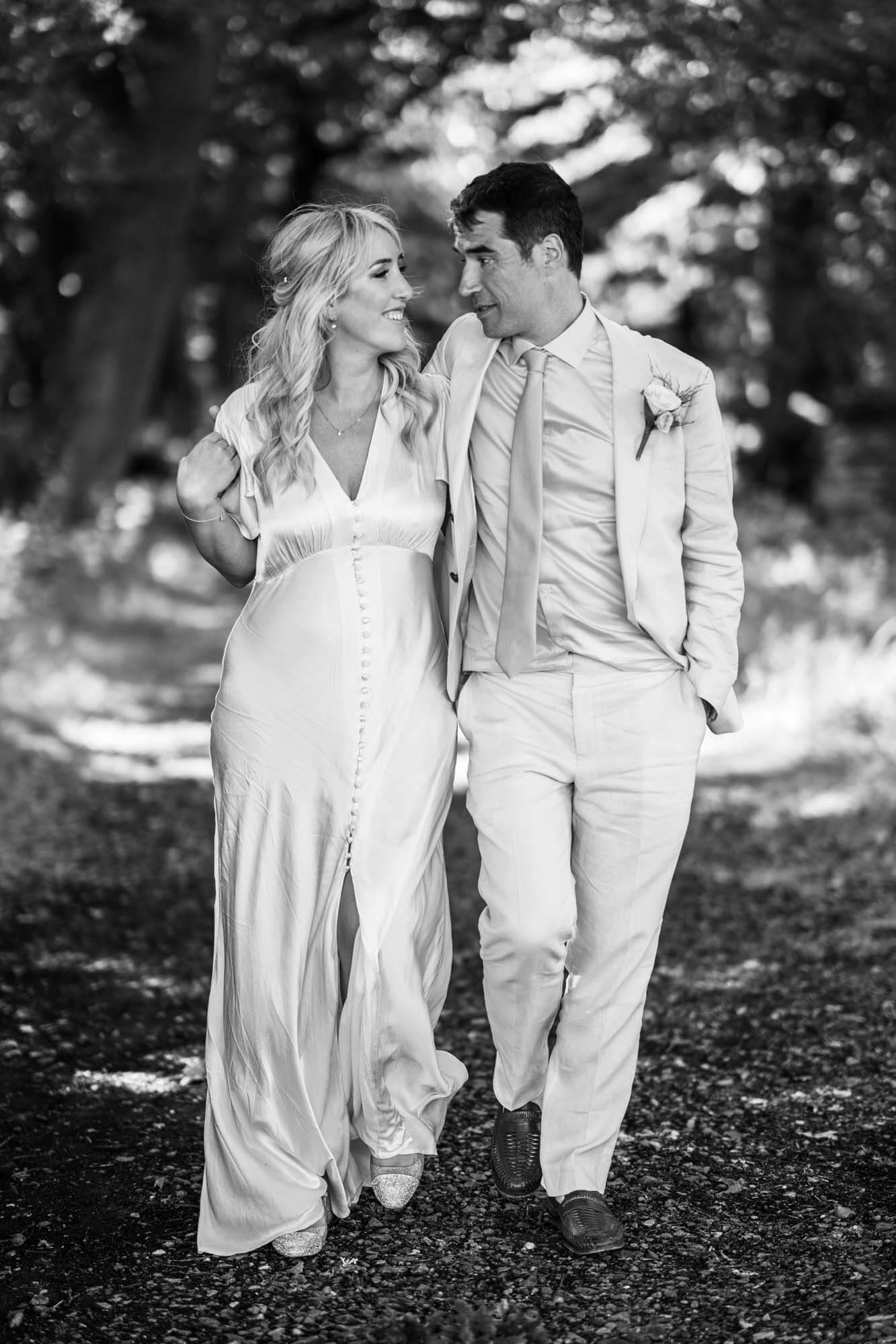 Bride and groom walking - B&W.
