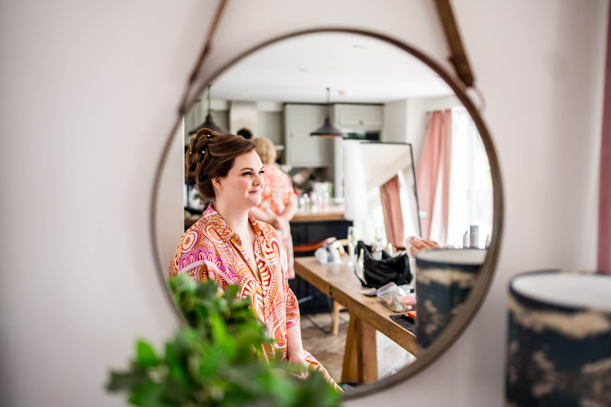 Bride getting ready in mirror.