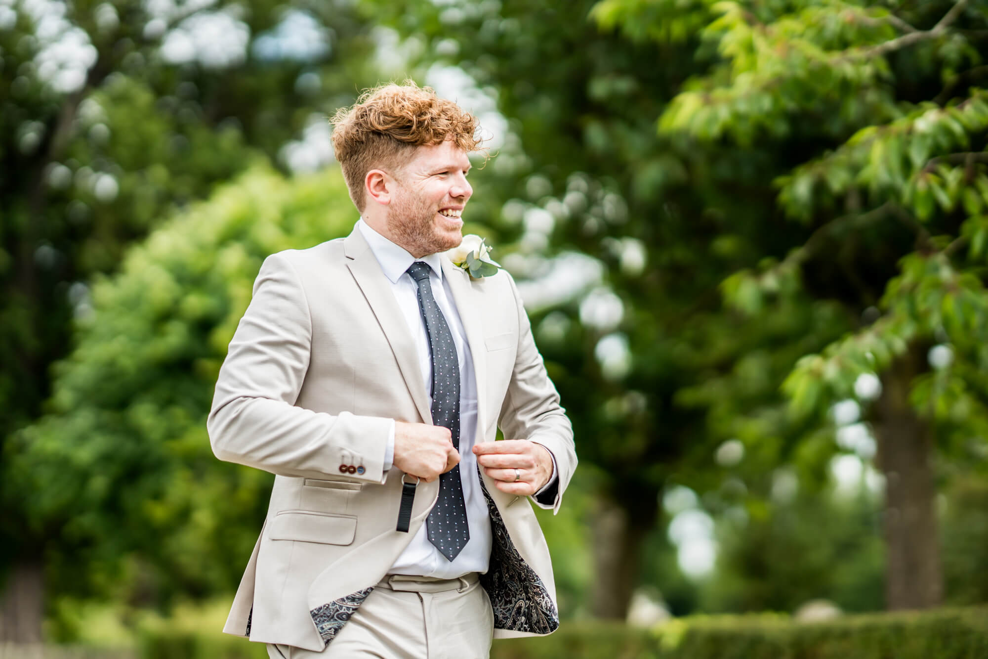 Cheerful wedding guest outside.