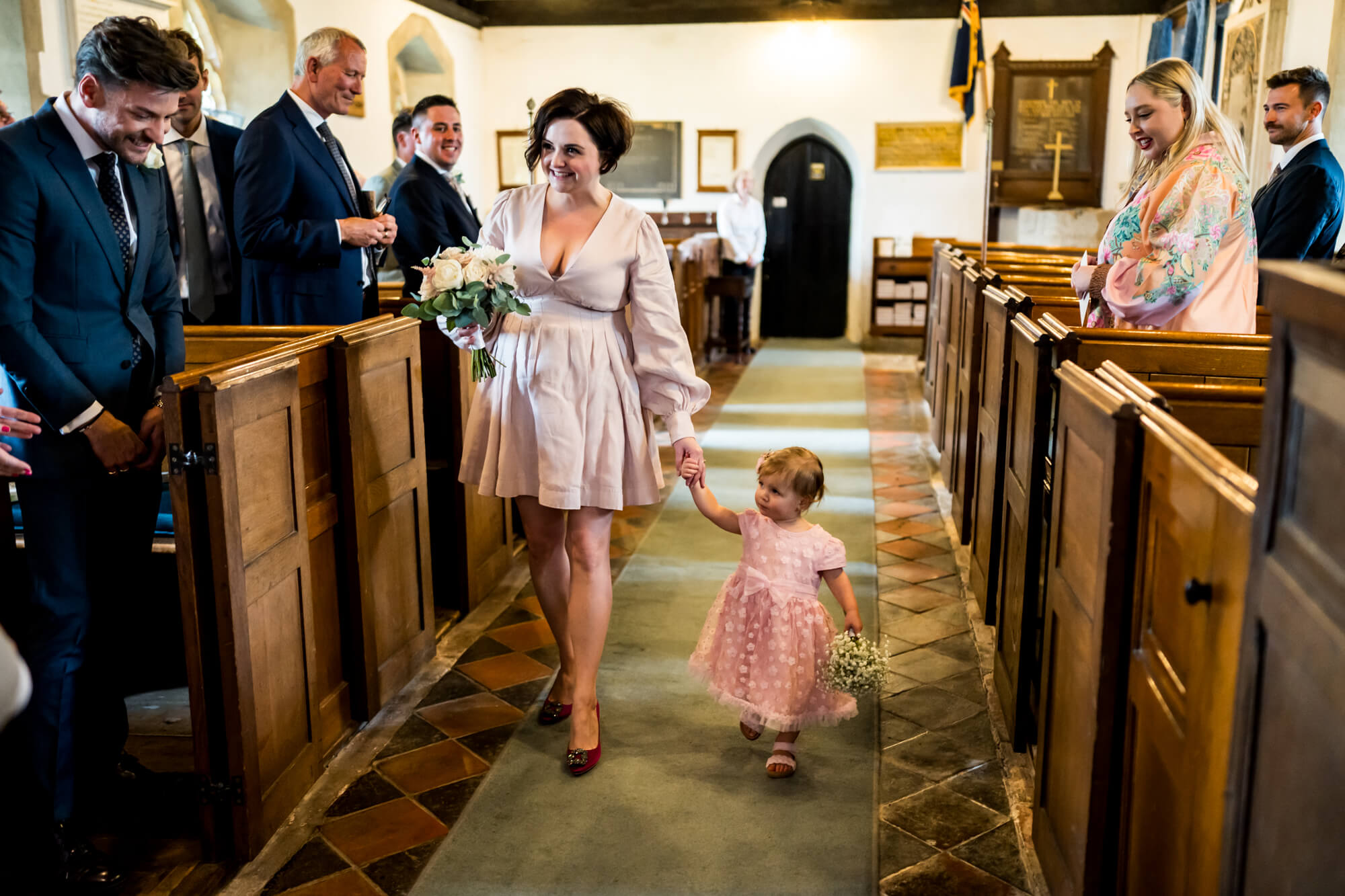 Bridesmaids walking down aisle.