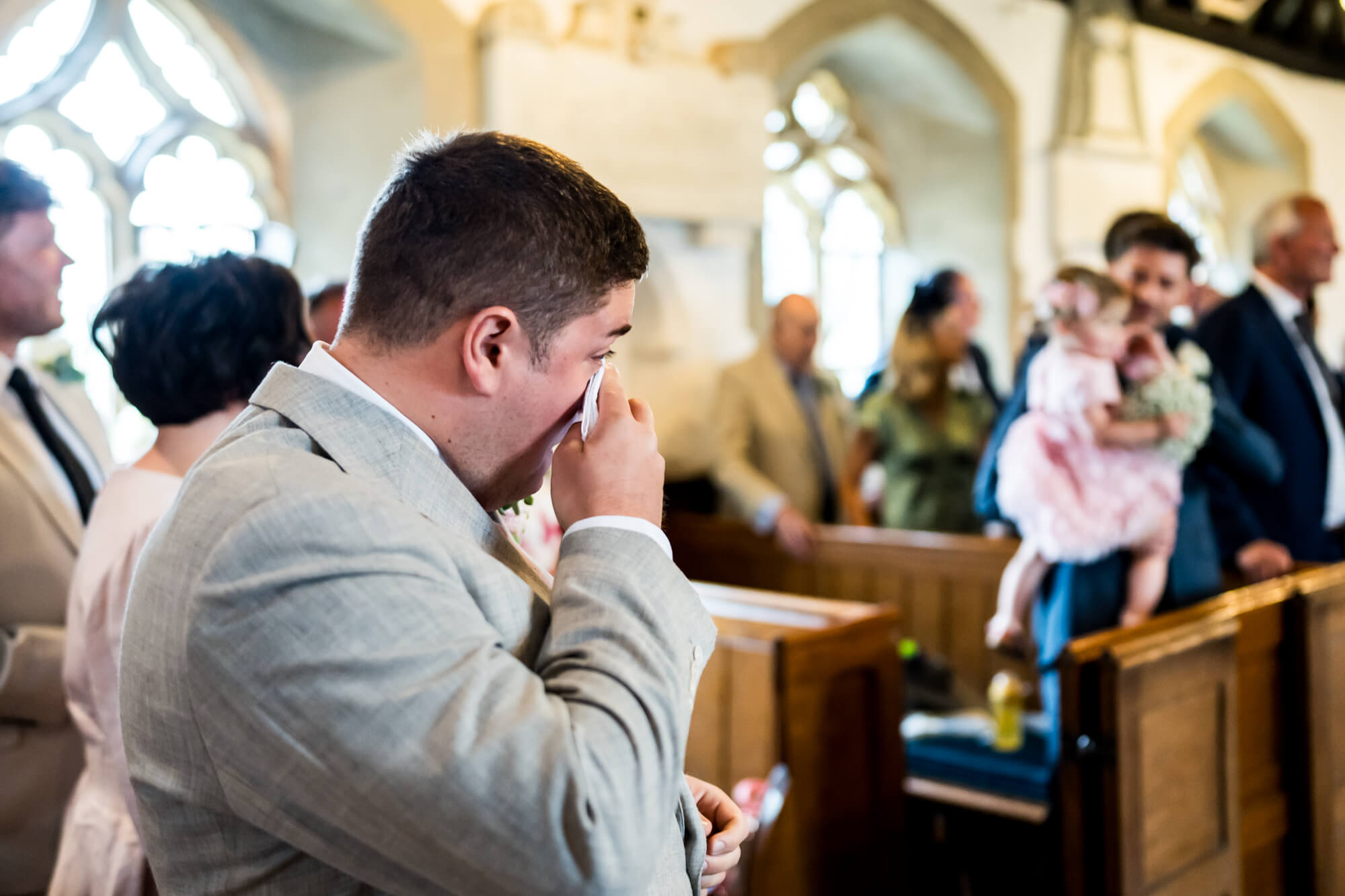 Emotional groom with handkerchief.