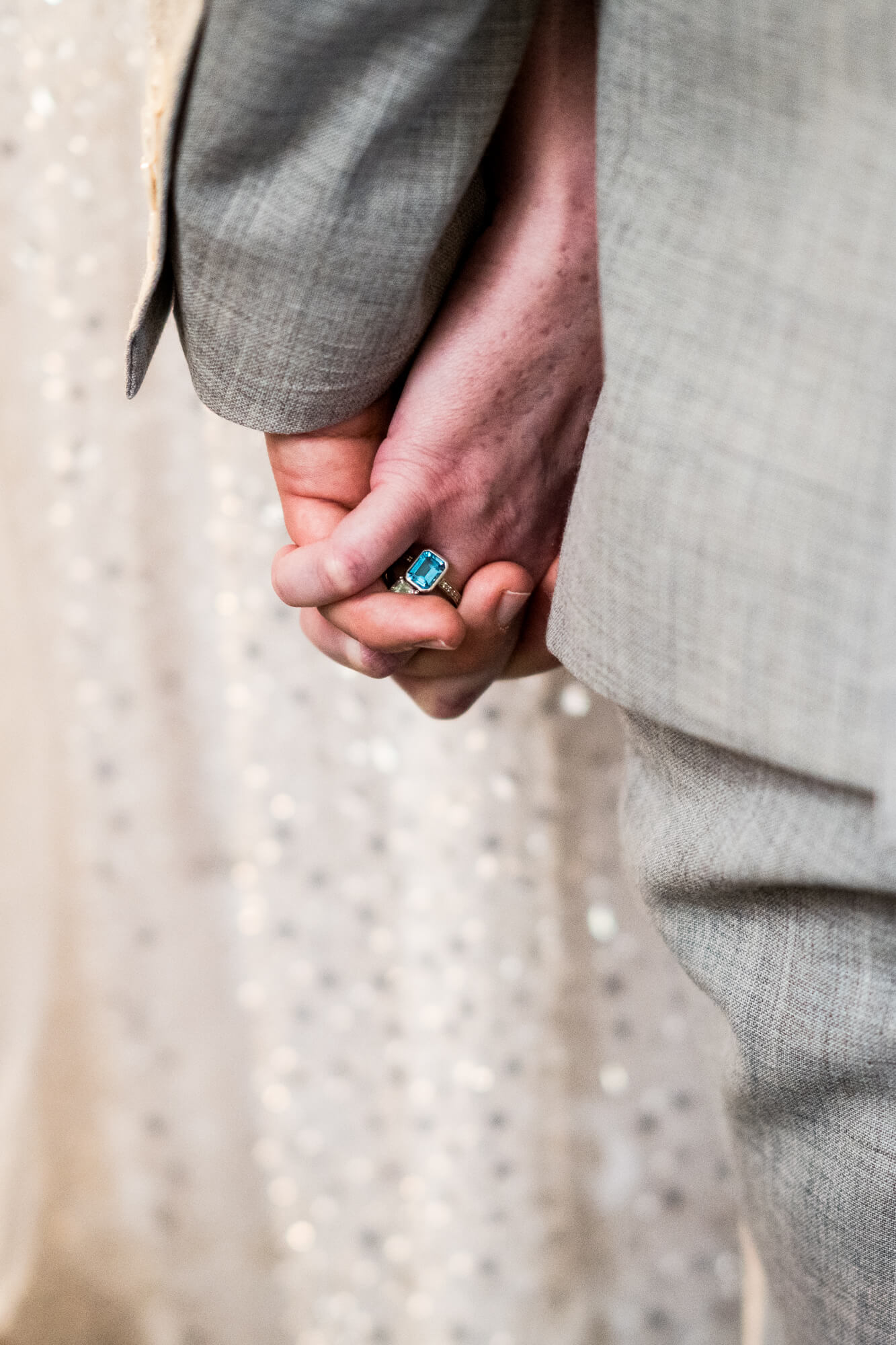 Groom and bride holding hands.