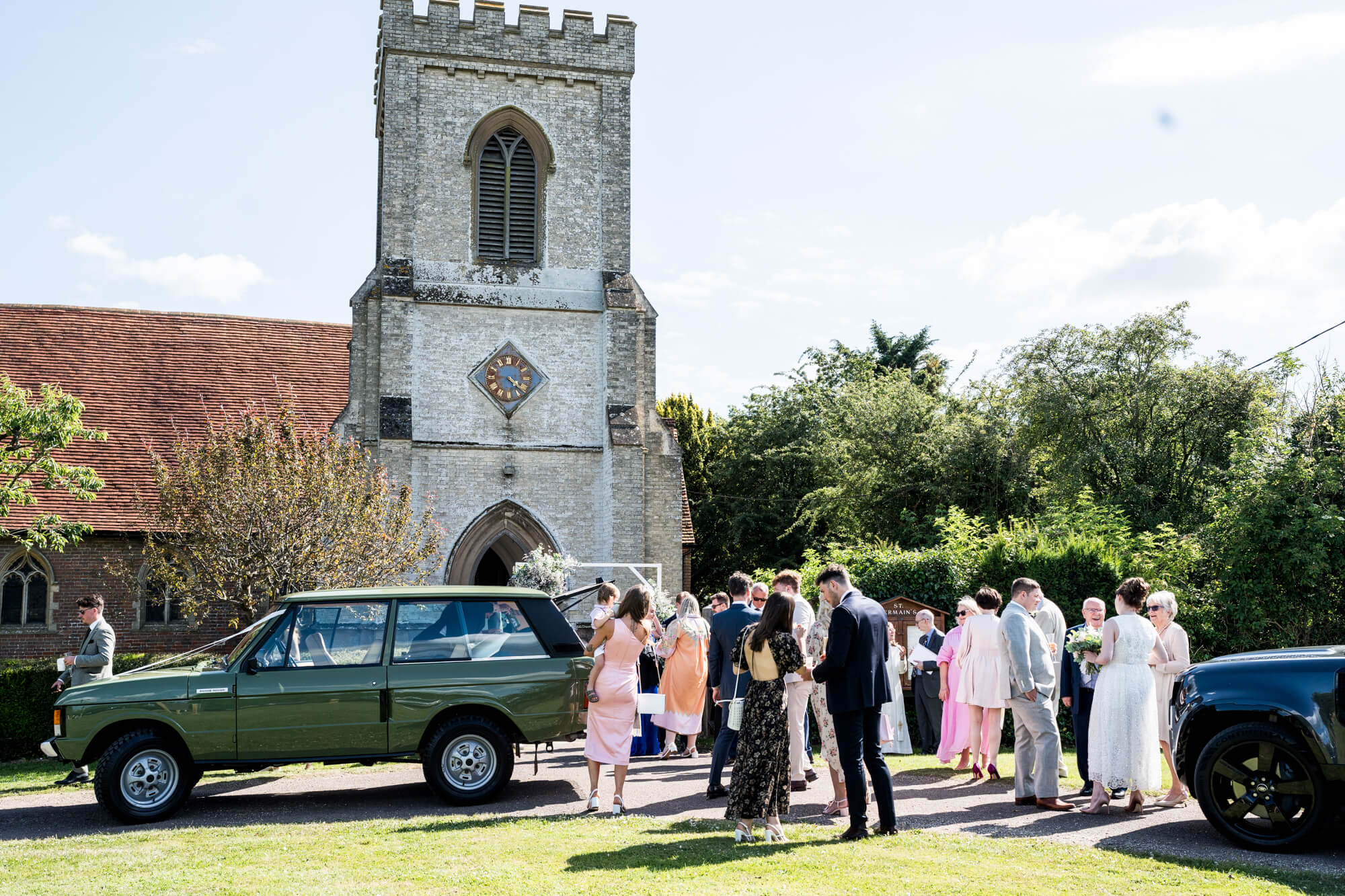 Guests outside wedding venue/ church.