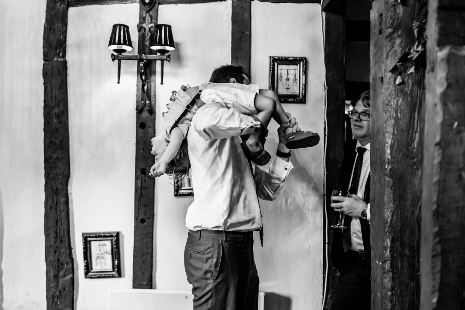 Man holding boy over his shoulder - B&W.
