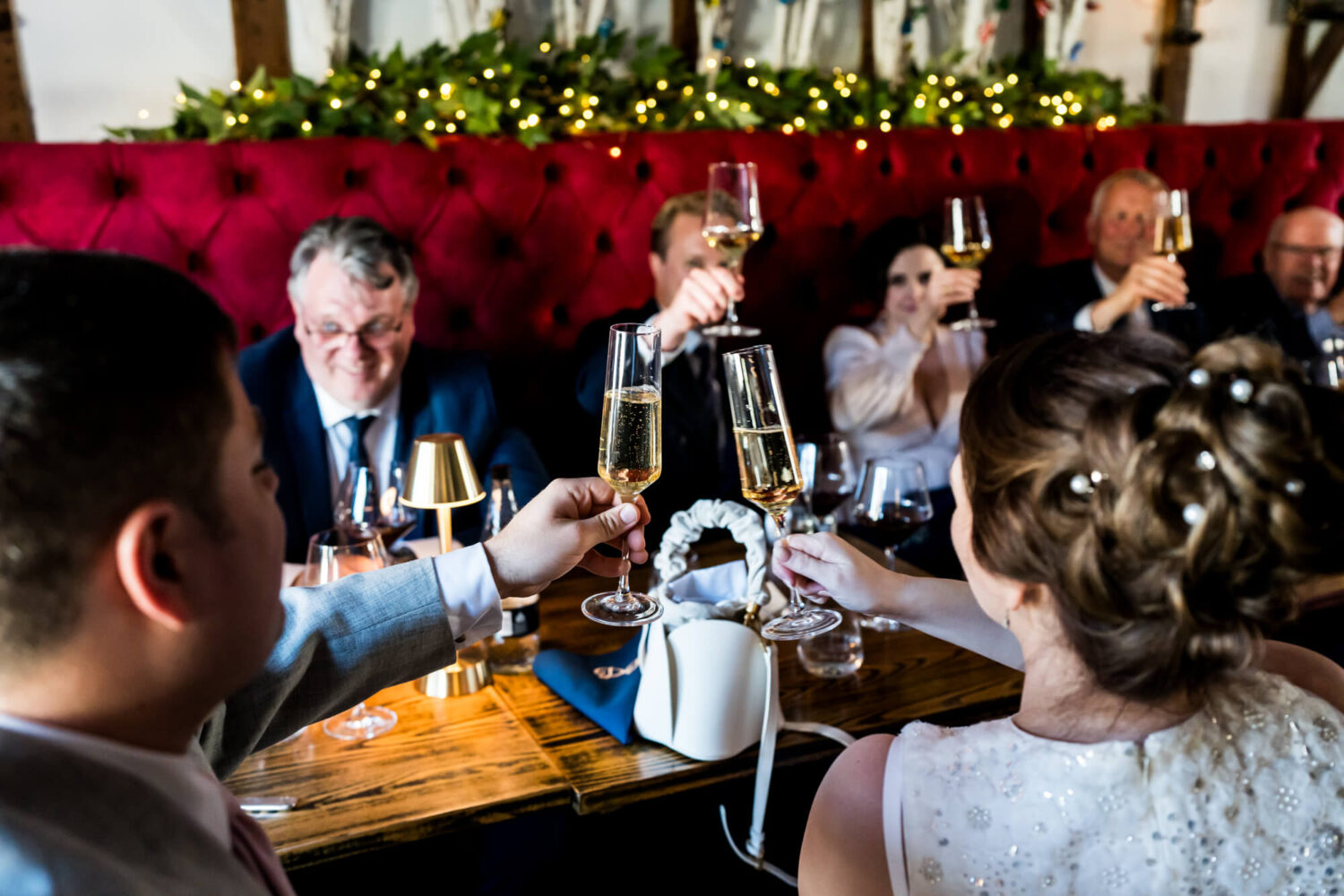 Wedding guests toasting at table.