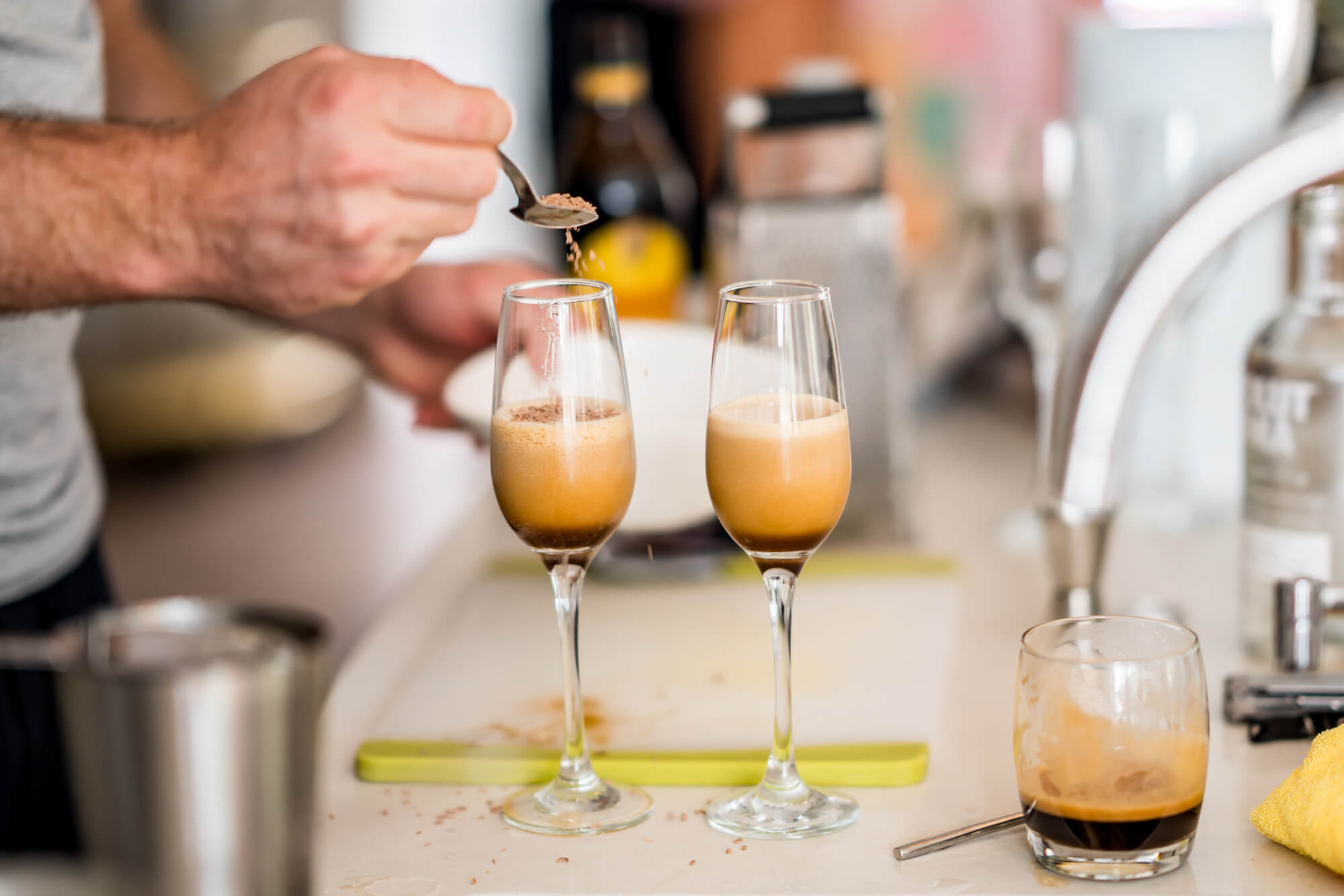 Man making two drinks.
