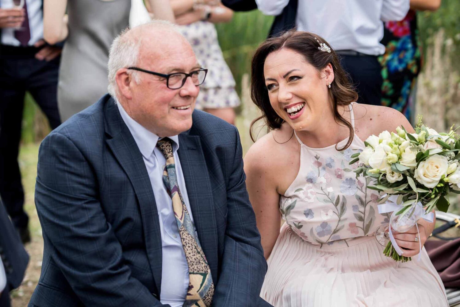 Father of the bride and his daughter sharing a joke.
