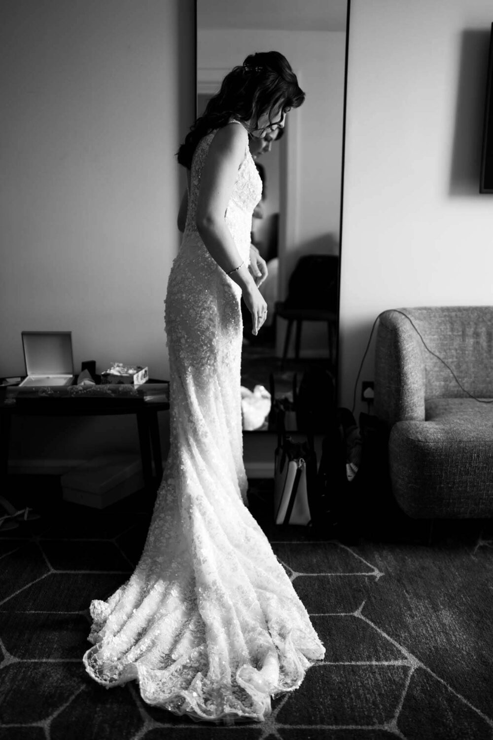 Portrait of bride standing in front of mirror in her dress london wedding