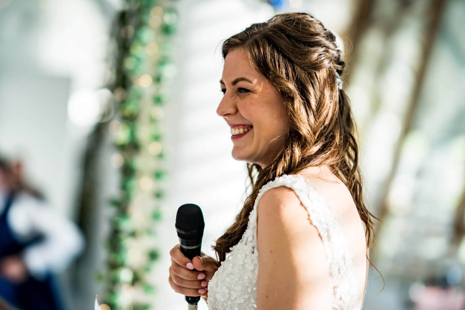 Close up of bride holding the microphone during her speech.