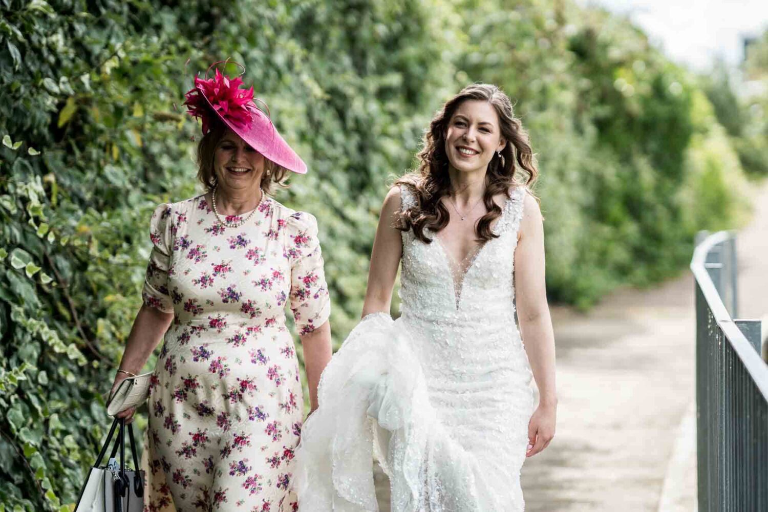 Mother of bride and bride walking towards venue.