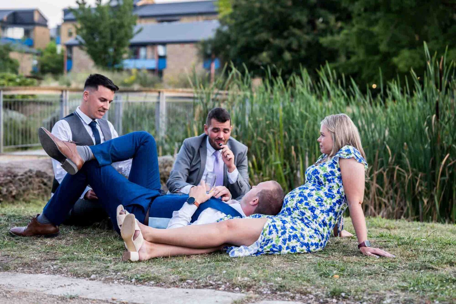 Guests lying on grass during evening party.
