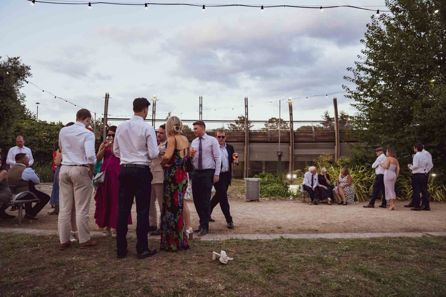 Upwards shot of the venue at dusk with guests in the foreground.