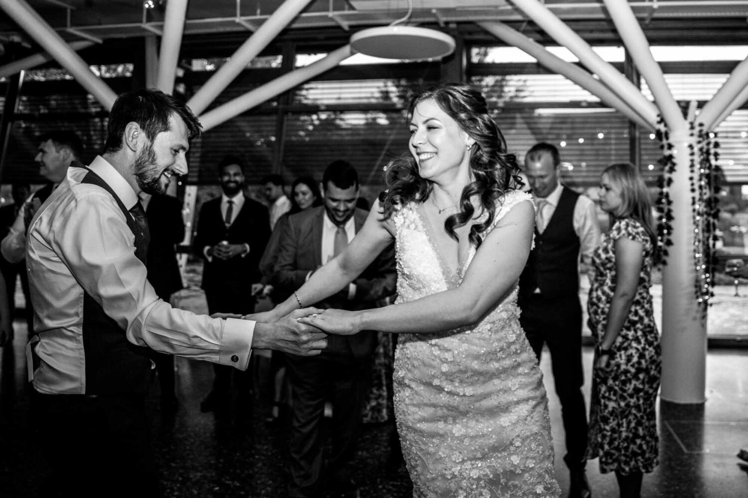 Bride being swung about dancefloor by her husband.