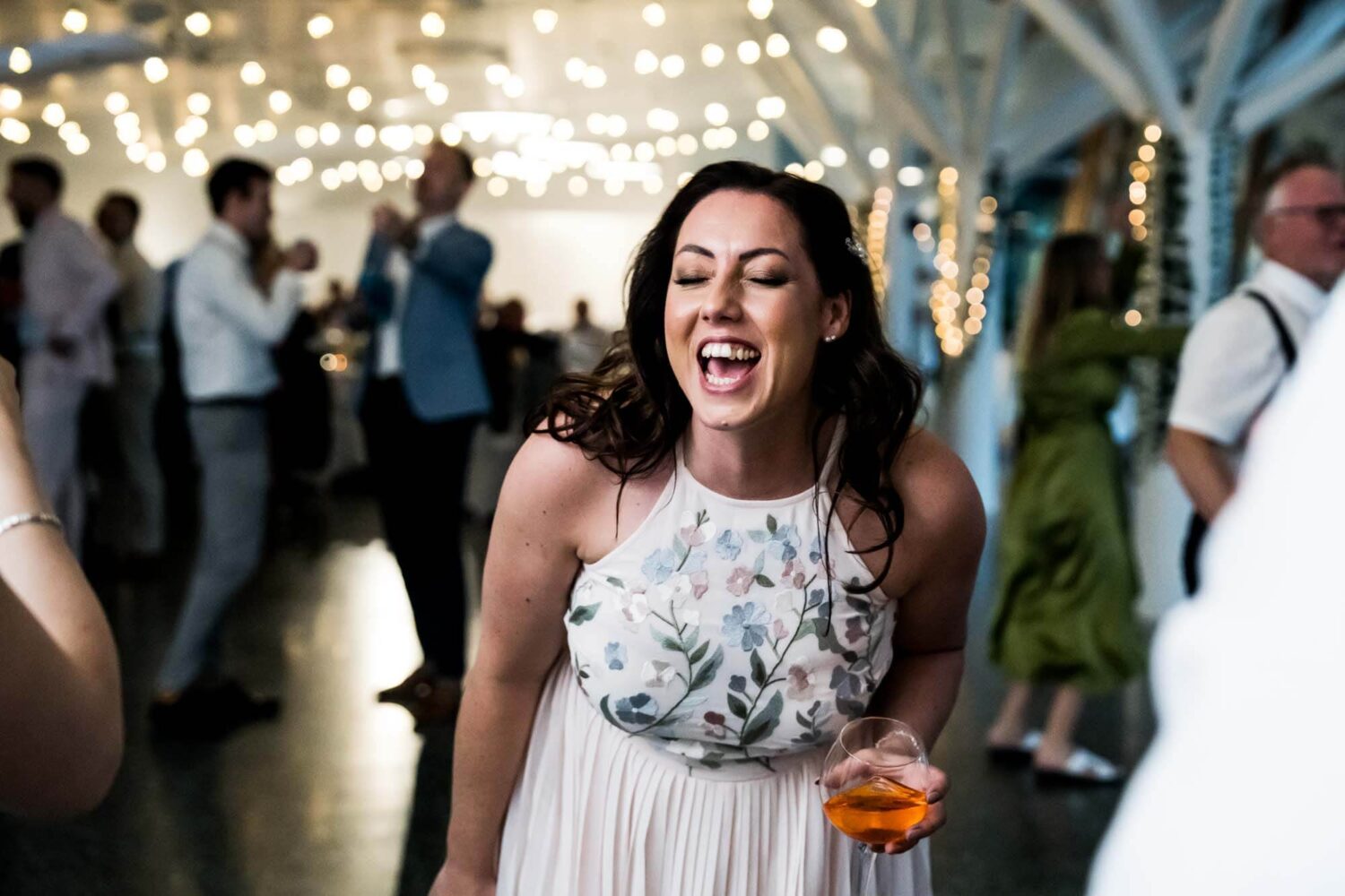 Guests dancing and laughing.