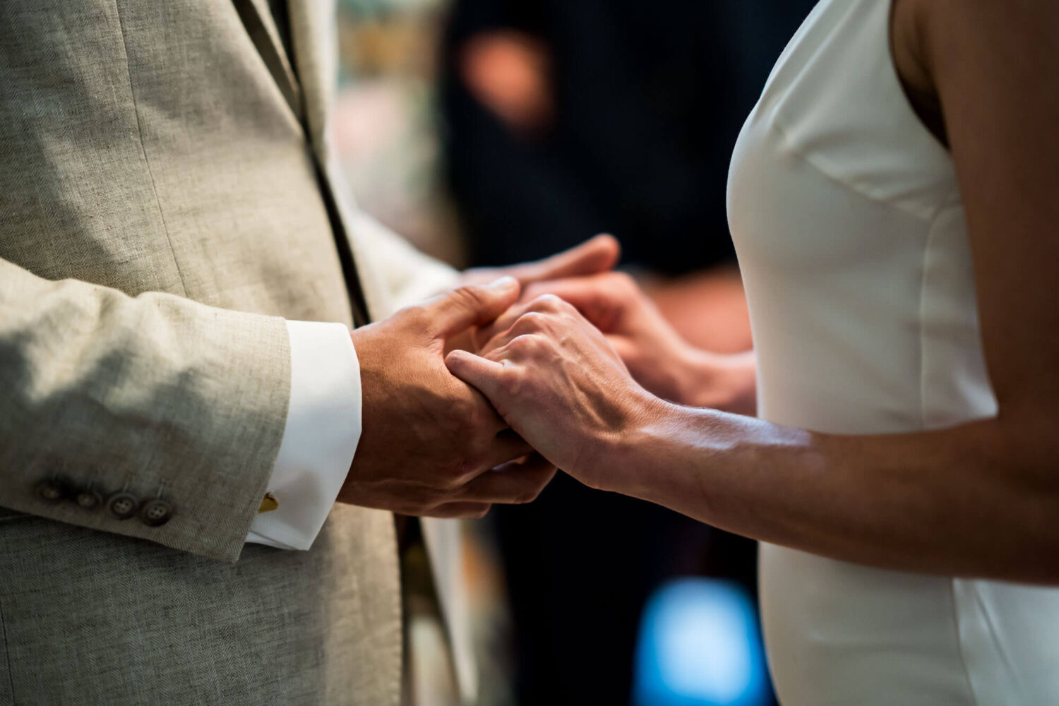 Close up of bride and groom holding hands Chelsea wedding.