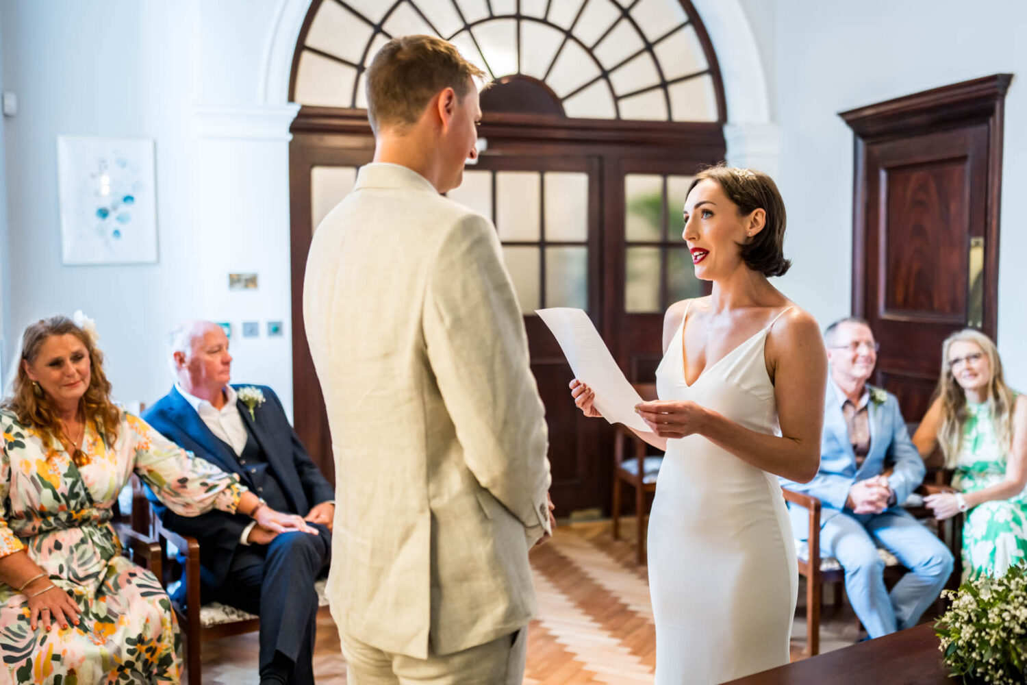 Bride reading to groom Chelsea wedding.