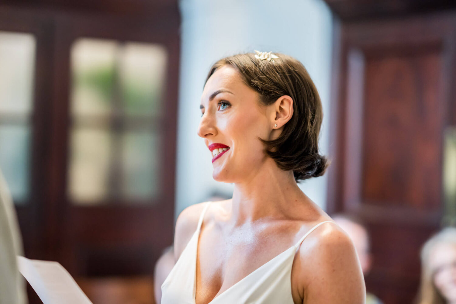 Bride reading to groom looking up at him. Chelsea wedding,.