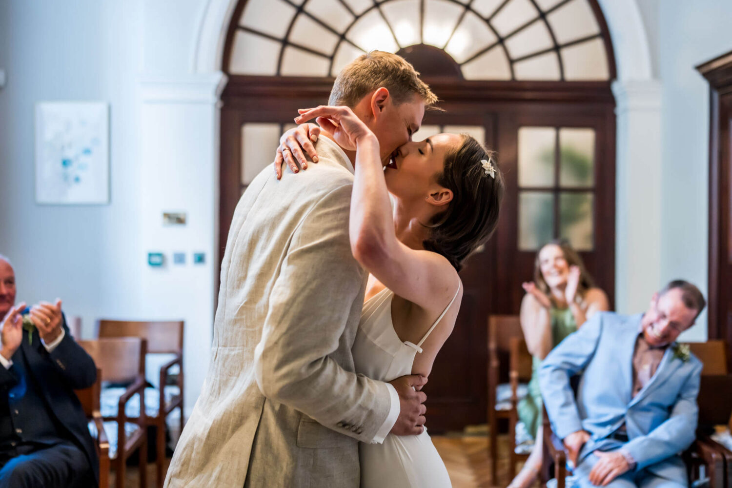 Bride embracing groom with a kiss Chelsea wedding.