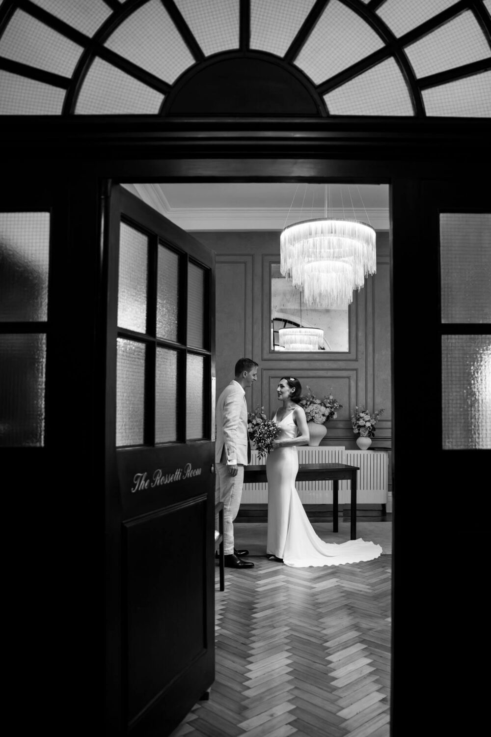 Peeking through the door at bride and groom having quiet moment Chelsea wedding.