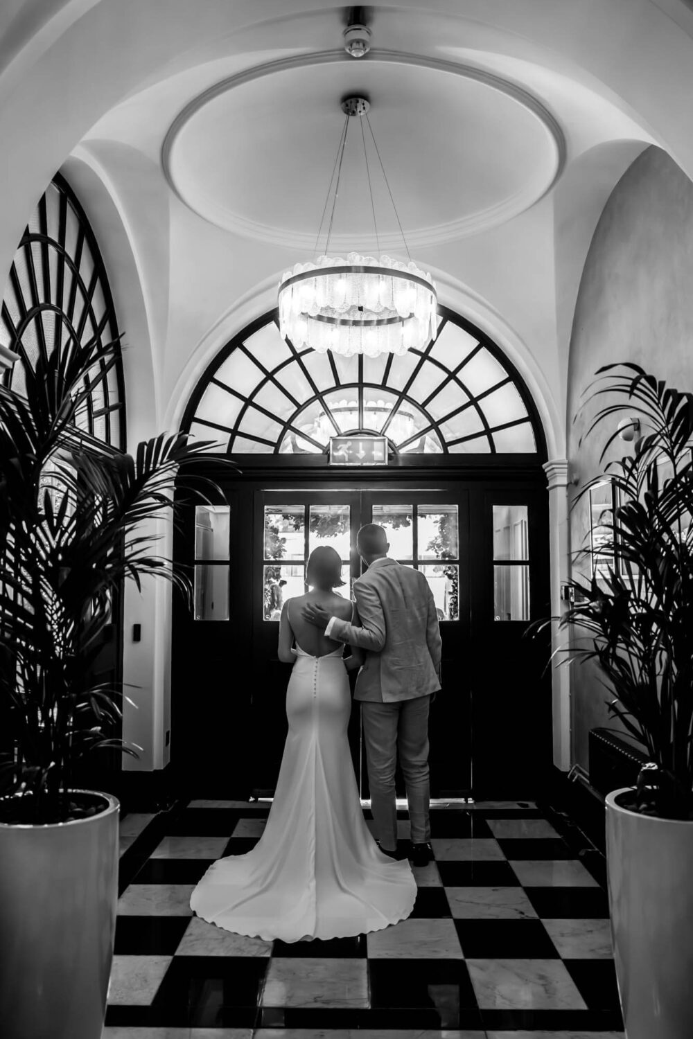 Photo from behind of bride and groom about to walk out onto Kings Road Chelsea wedding.