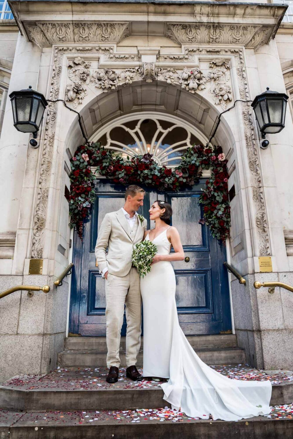 Bride and groom looking at each other outside the iconic Chelsea doors Chelsea wedding.