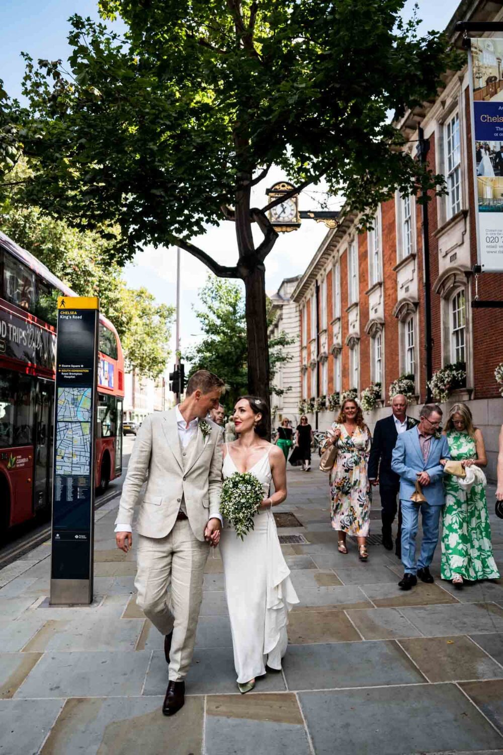Wedding party walking along the Kings Road Chelsea wedding.