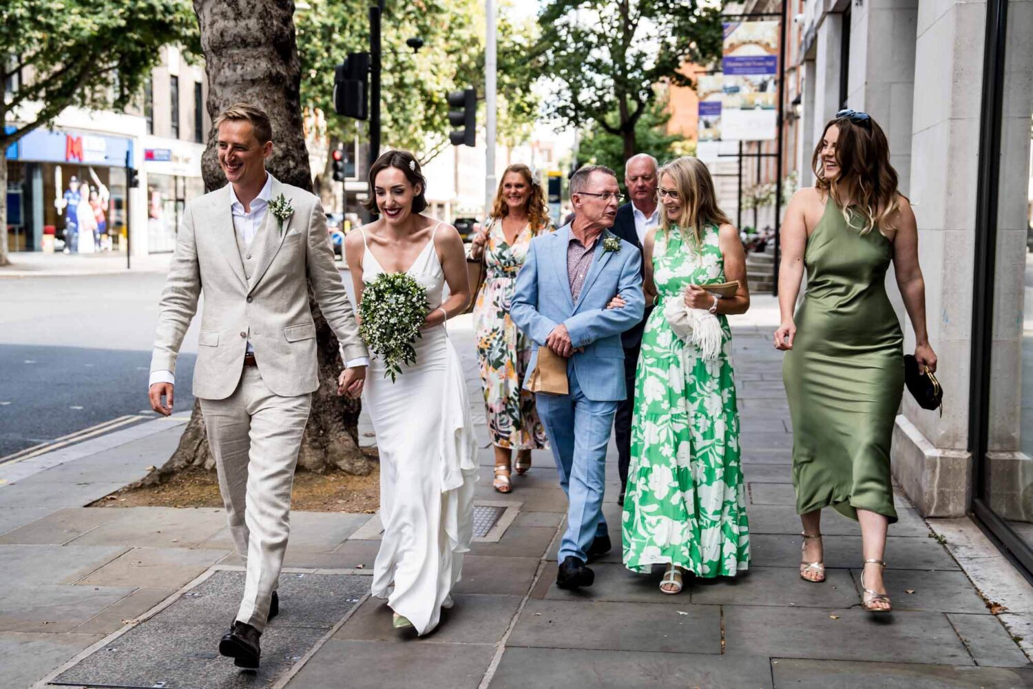 Wedding party walking along the Kings Road Chelsea wedding.