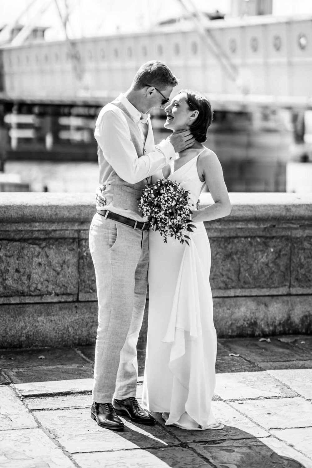 Groom gently touches bride's neck almost kissing Chelsea wedding.