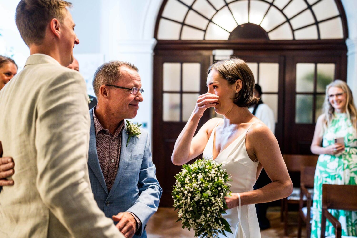Bride wiping away a tear on seeing husband Chelsea wedding.