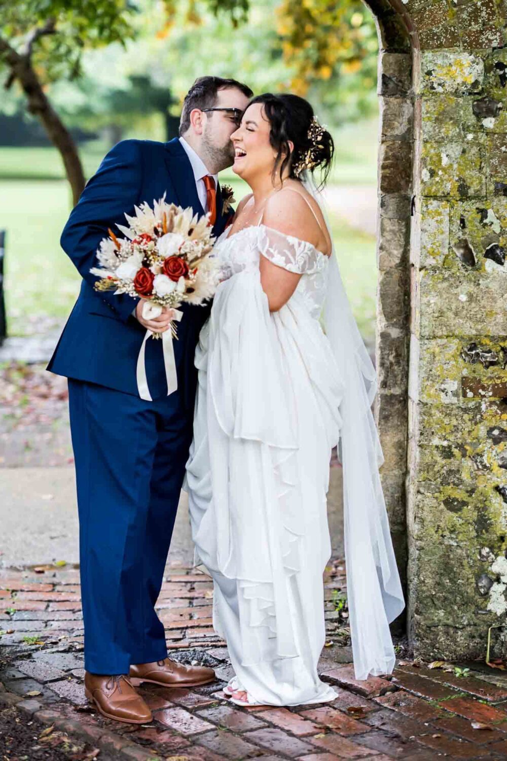 Groom making bride laugh in southover grange gardens Lewes wedding.