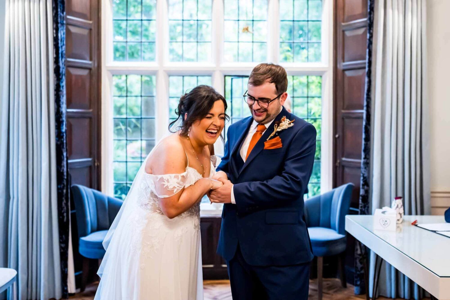 Bride laughing with groom by side during ceremony Lewes wedding.
