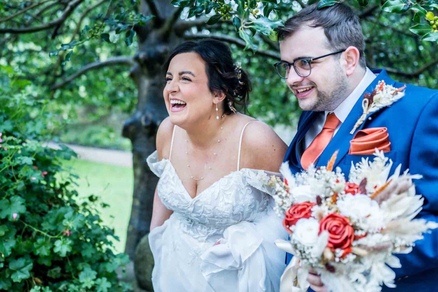 Bride laughing with groom walking outside having just got married Lewes wedding.