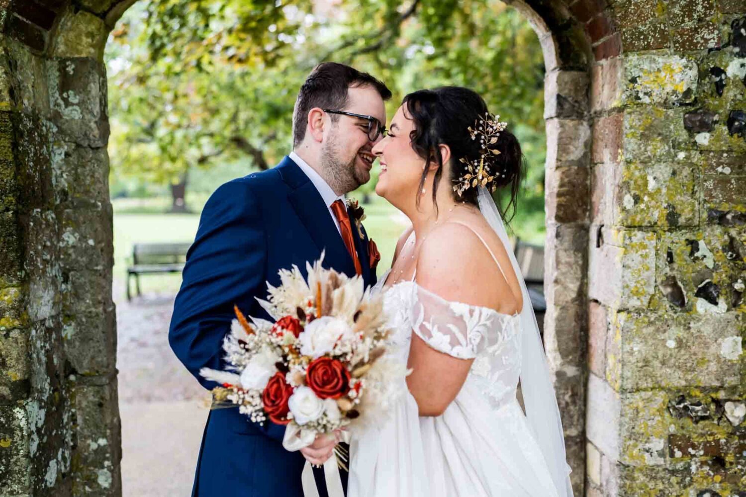 Groom making bride laugh in southover grange gardens Lewes wedding.