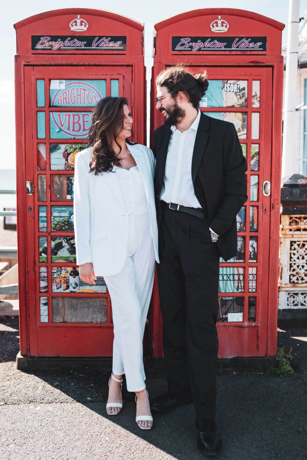 Man and woman standing in front of Brighton telephone boxes Brighton wedding.