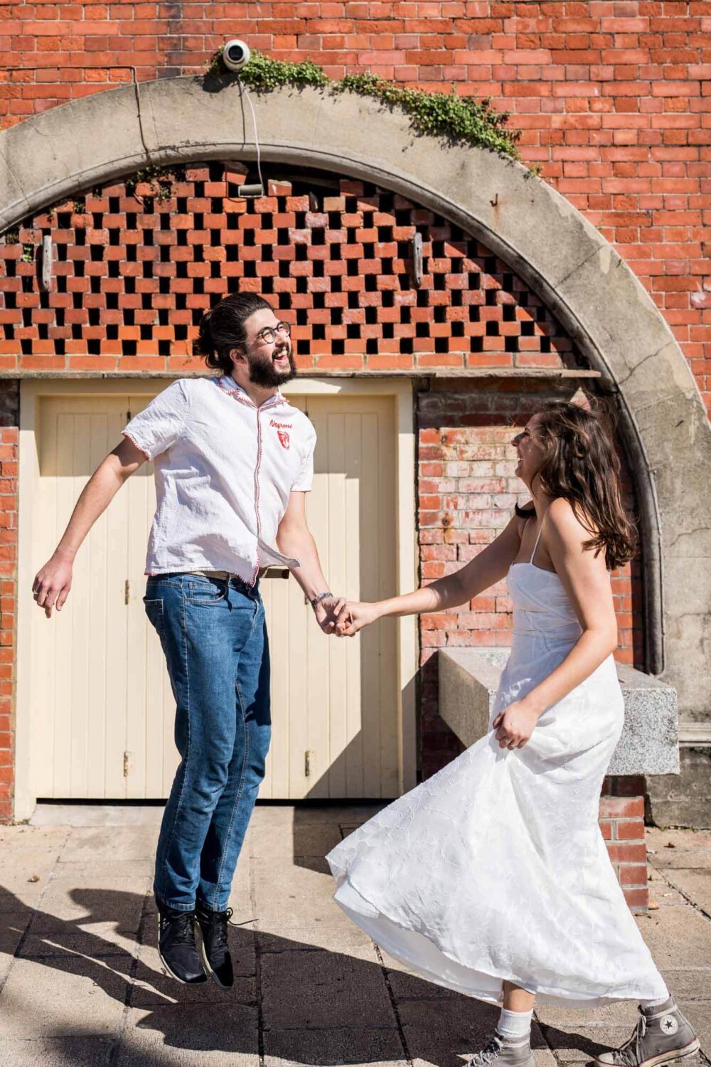 Couple having fun dancing under Brighton's seafront arches Brighton wedding.