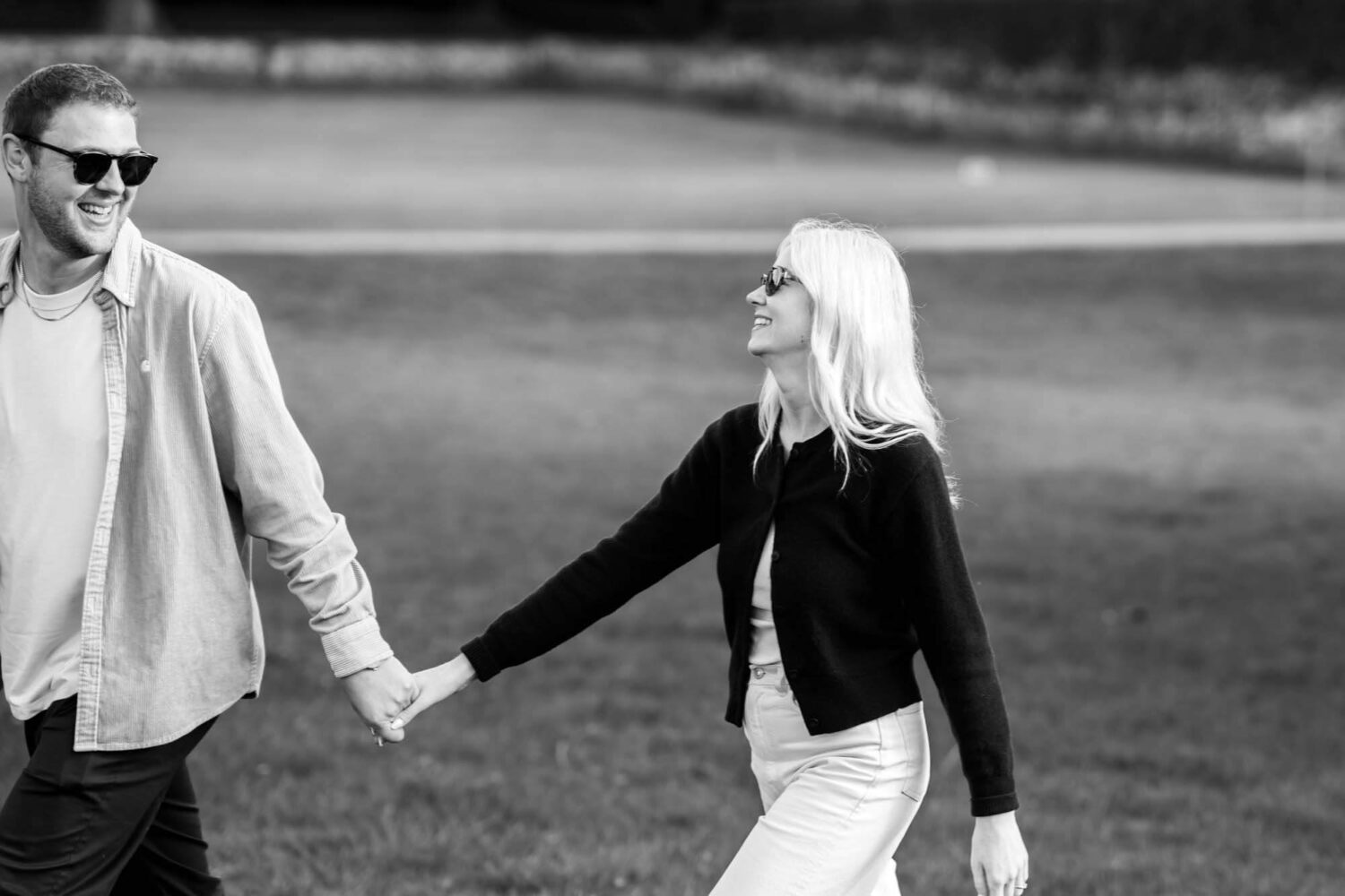 man and woman holding hand smiling at each other
